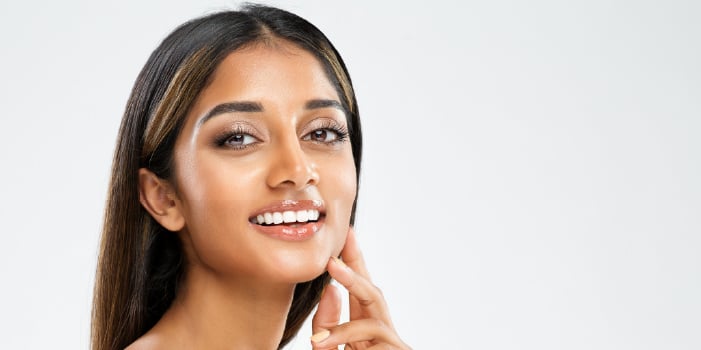 Beautiful woman with glowing skin who uses CBD products