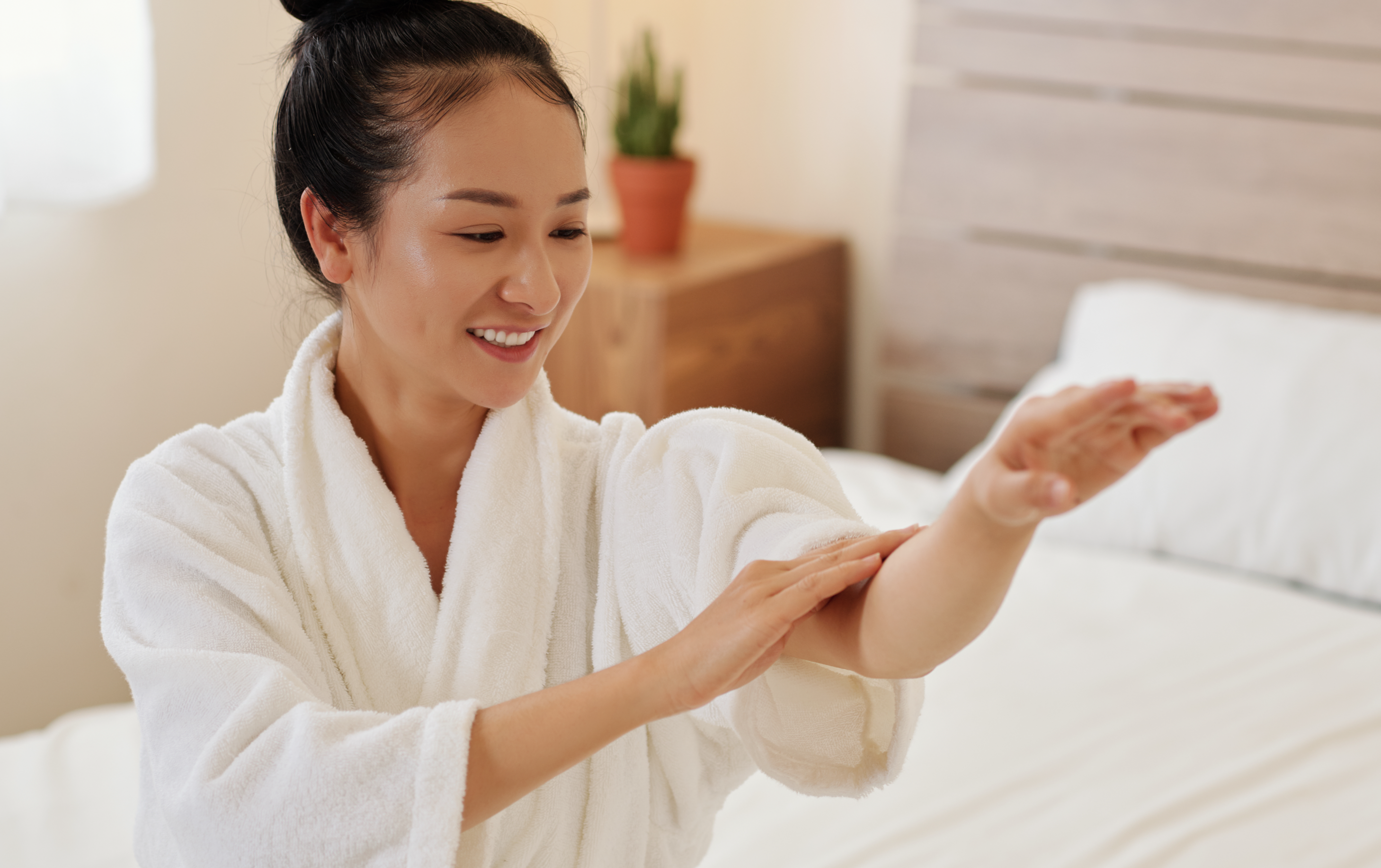 woman applying CBD skincare to arm for skincare benefits