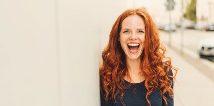 A happy woman with a boost of positive self-esteem.