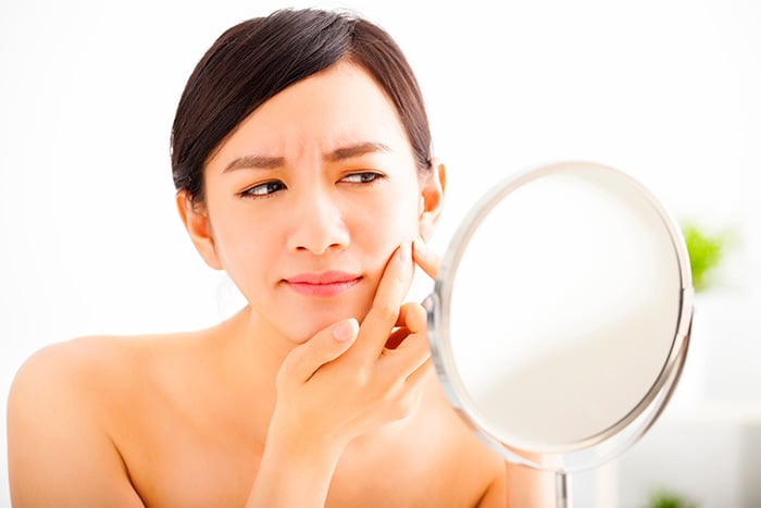 Woman concerned about making common skin care mistakes.