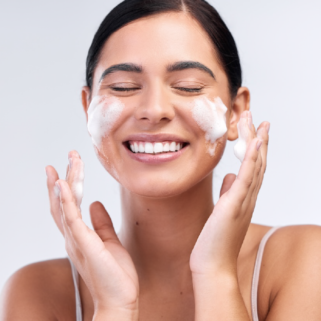 woman using active cleanser to wash face