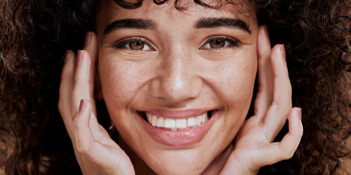 A woman with repaired, healthy skin smiling