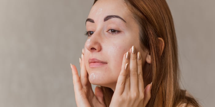 Woman treating skin that is purging from using new professional skin care.