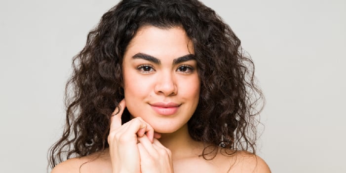 Woman who healthy skin from using professional skincare with peptides.