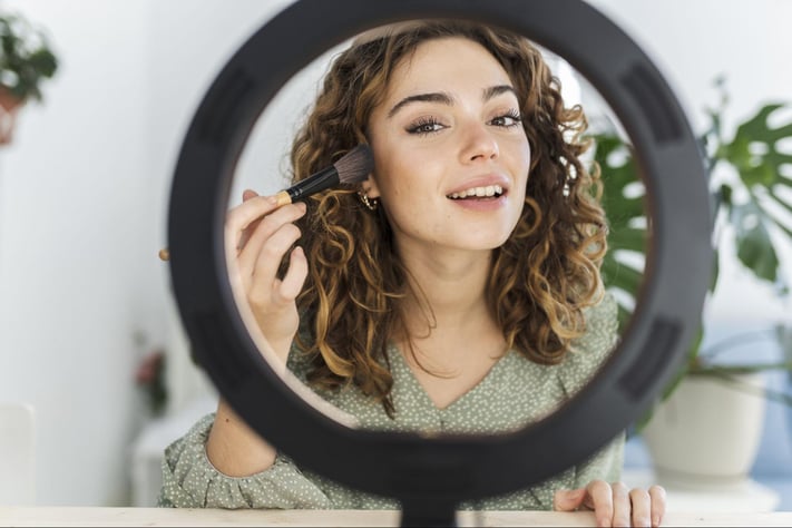 Woman using hybrid makeup products
