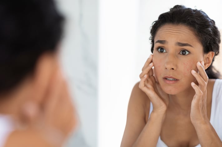 woman washing face with skincare for textured skin