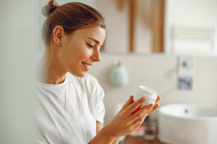 woman looking at sun ingredients on sunscreen