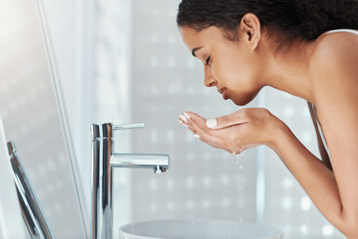girl washing face to determine skin type