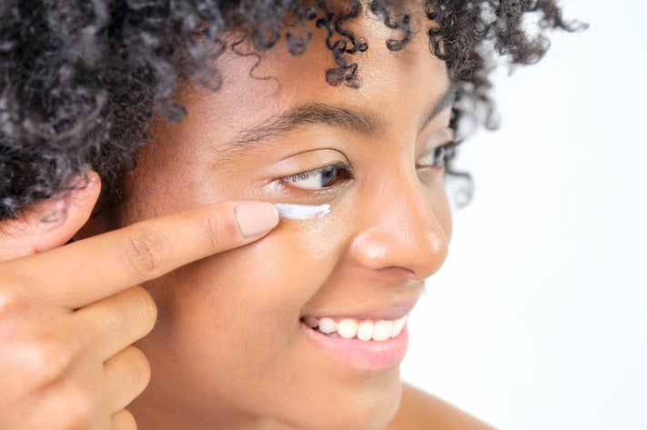 woman applying cbd eye cream