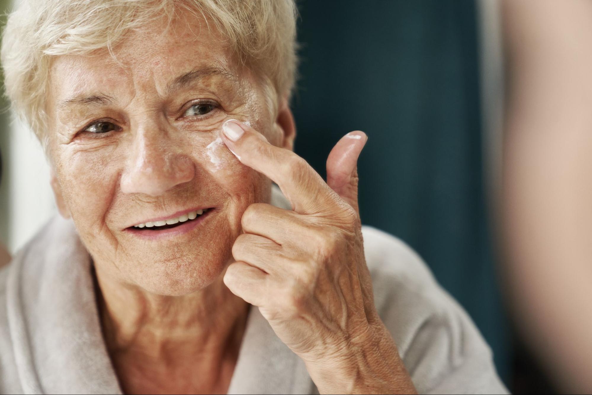 mature woman applying anti-aging skincare