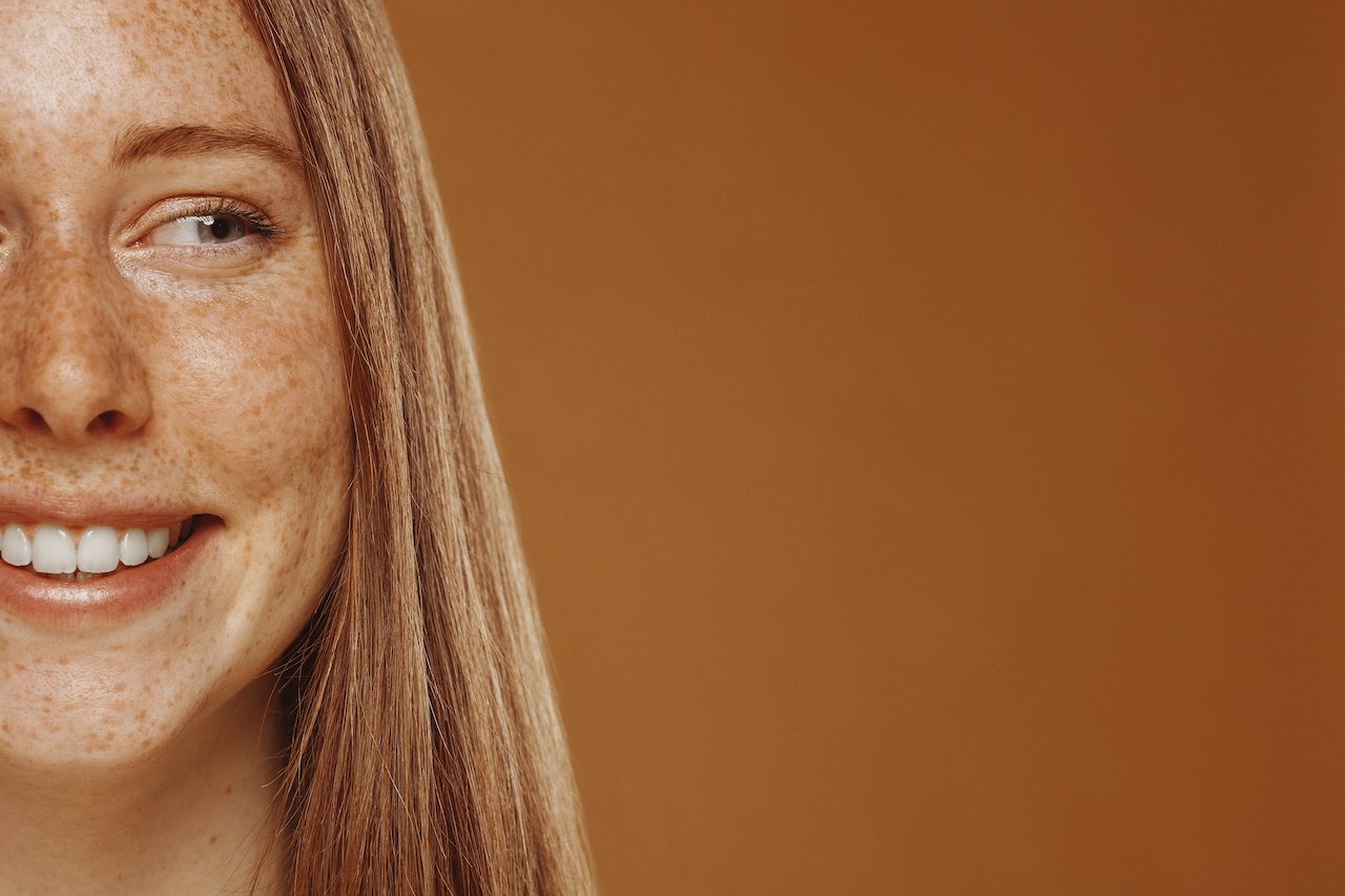 Close-up of a young woman with freckles