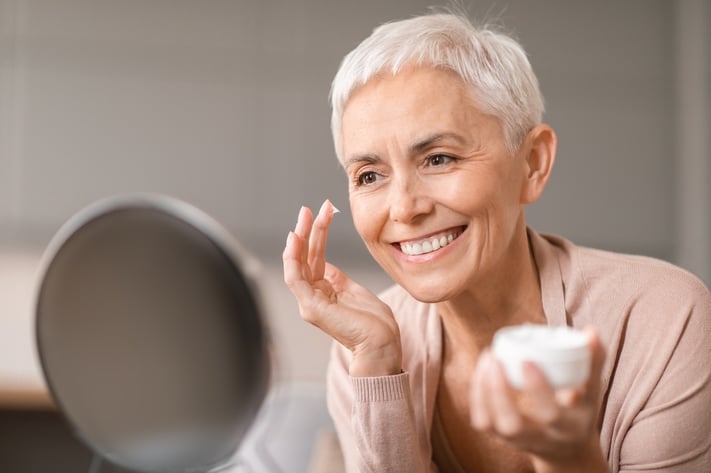 mature woman using Retinol product with hydrating ingredients