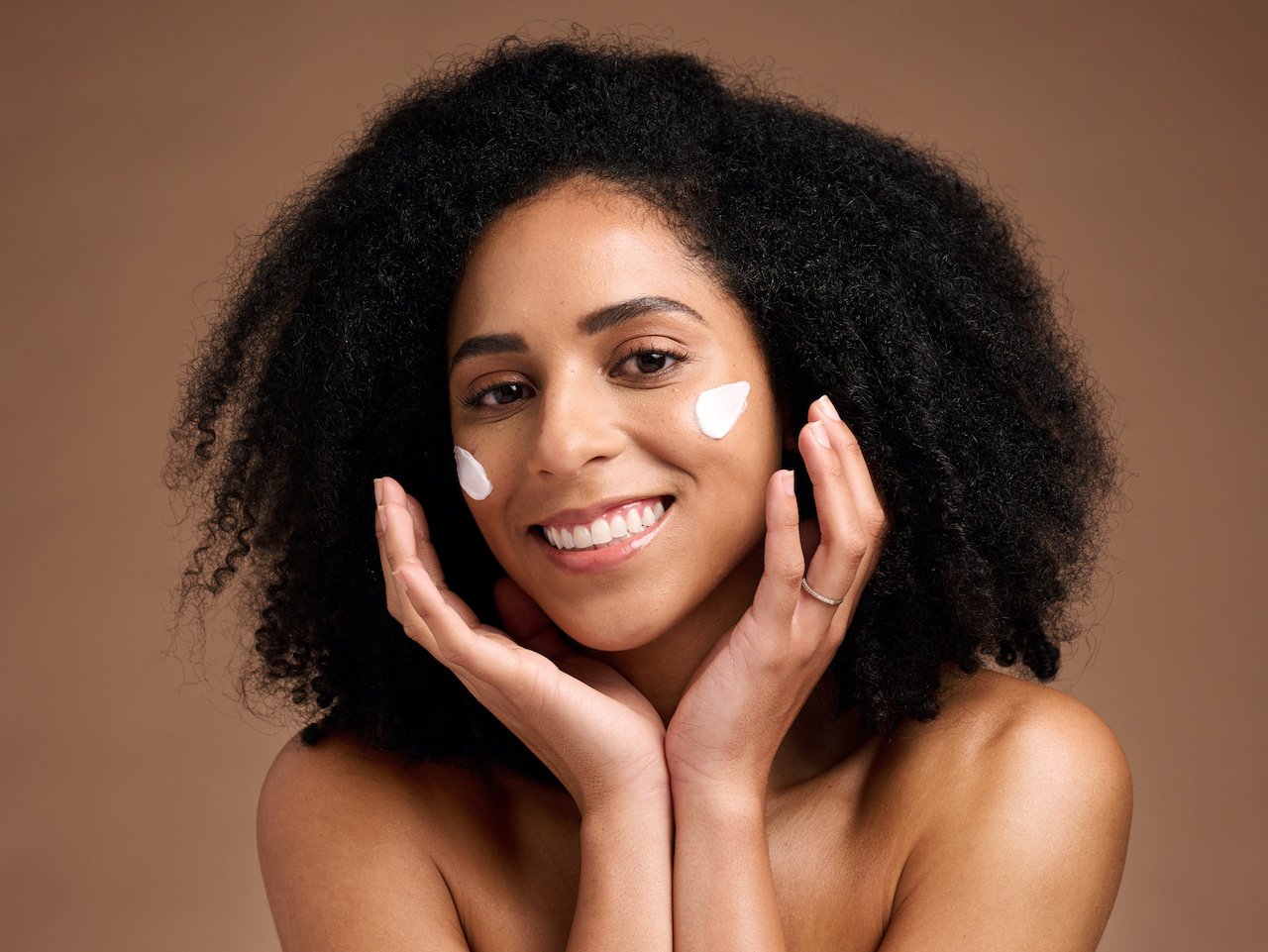 Woman applying sunscreen