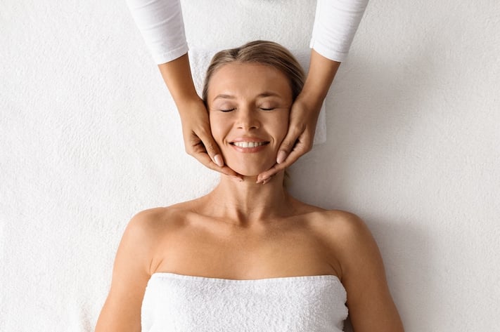 women getting a facial to help with holiday glow
