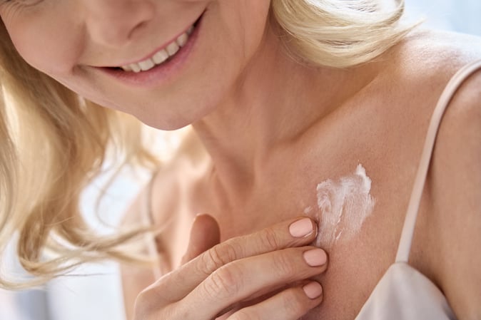 Woman applying hyperpigmentation skincare products