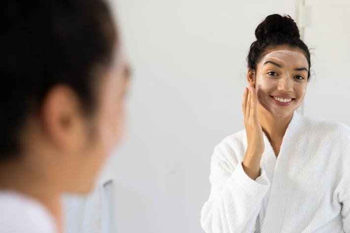 Woman using gentle exfoliator to avoid over exfoliated skin