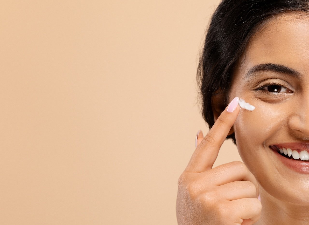 woman using under eye cream
