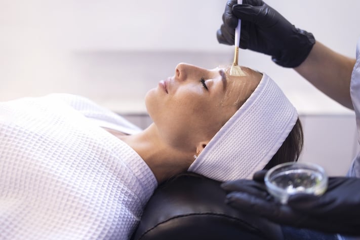 Skincare professional applying chemical peel