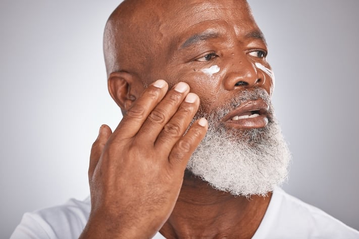 man applying moisturizer to boost skin’s firmness