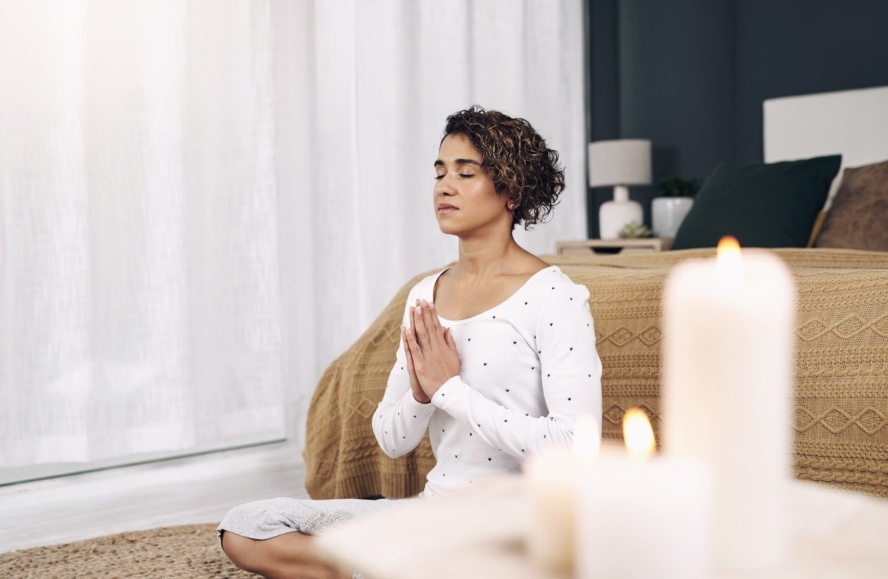 woman managing her stress with meditation