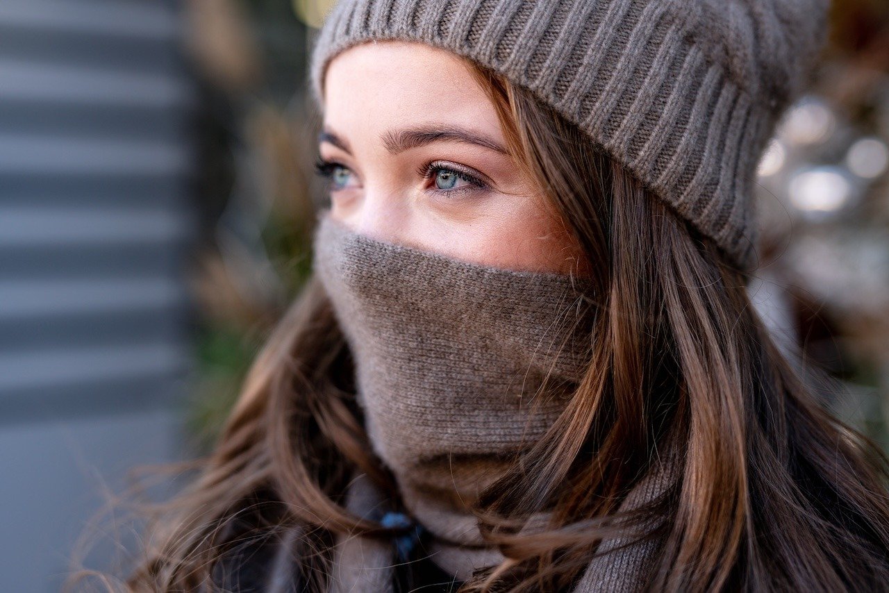 woman protecting lips from the elements