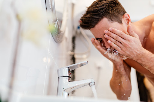 Man washing face with products containing benzoyl peroxide